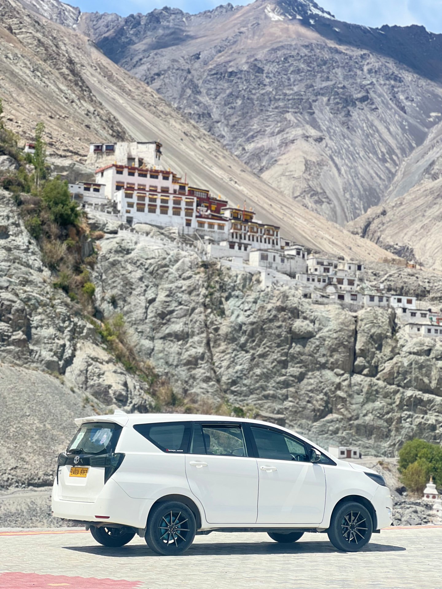 White Innova Crysta below Diskit monastery in Nubra Valley