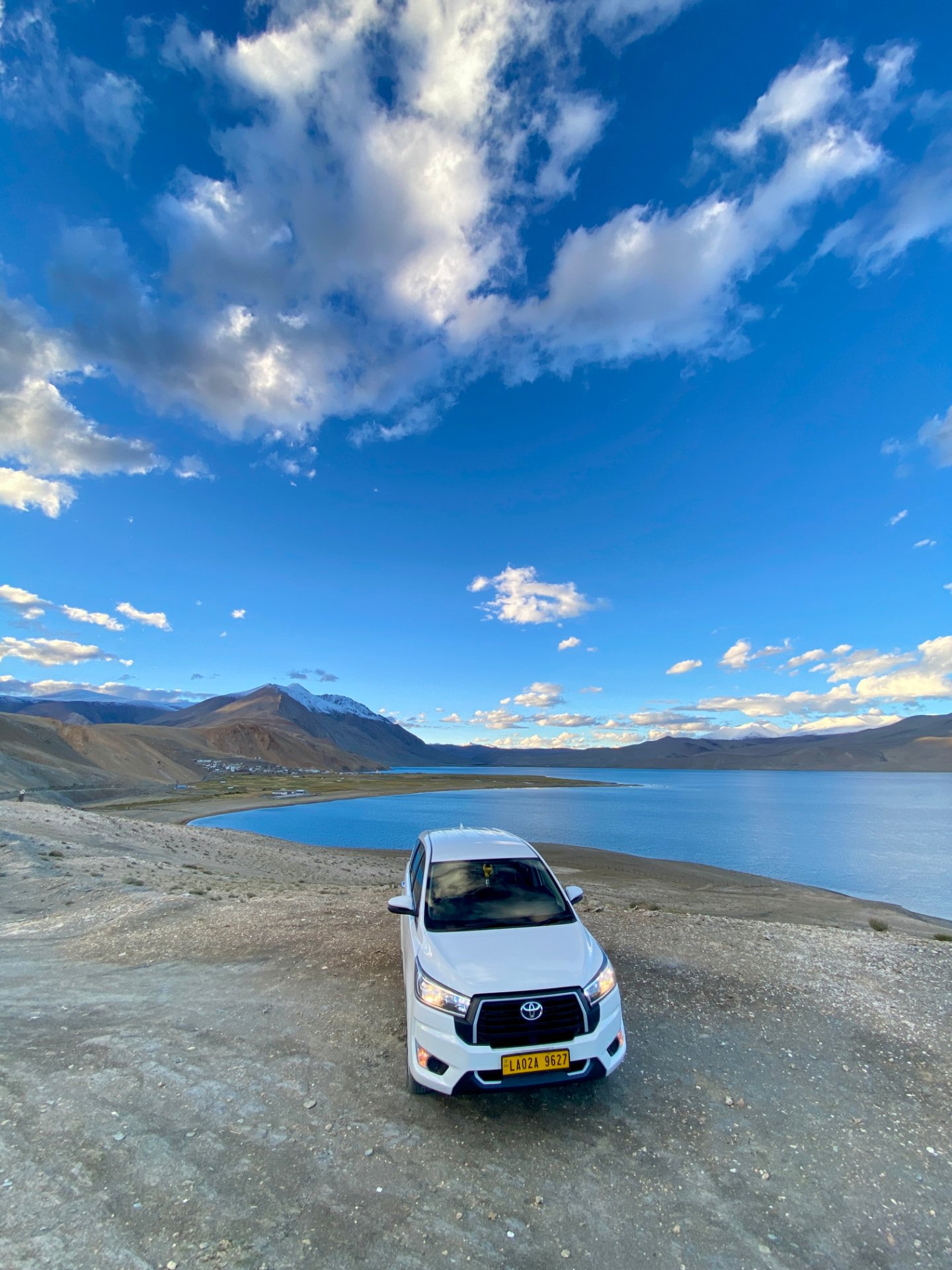 White Innova overlooking Tso Moriri lake in Ladakh